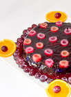 Gluten Free Recipe of Jelly Cake on white plate decorated with grapes and oranges