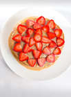 No-bake cake with strawberries on top on a white plate