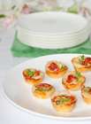 Party Finger food Mini Muffins with semi dried tomatos on a white plate