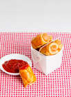 Chicken Sausage Rolls in a white party box with tomato sause
