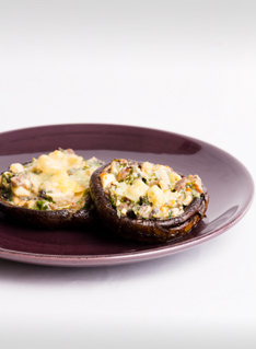 party appetiser of stuffed mushrooms on a brown plate